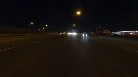 POV driving plate reverse shot roads and highways on a very dark night Stock Footage 155895021