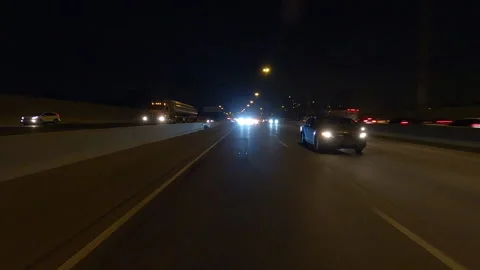 POV driving plate reverse shot roads and highways on a very dark night Stockbeeldmateriaal 155895472