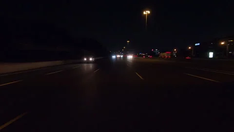 POV driving plate reverse shot roads and highways on a very dark night Stock Footage 155897149