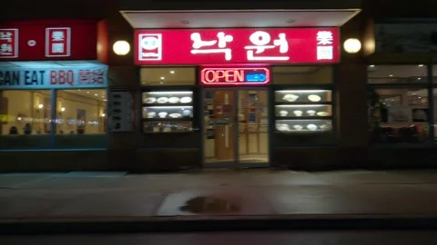 POV driving plate side view of closed retail stores at night in COVID lockdown Video stock 149464219