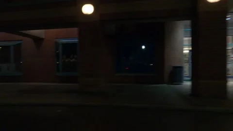 POV driving plate side view of closed retail stores at night in COVID lockdown Vídeos de archivo 149464576