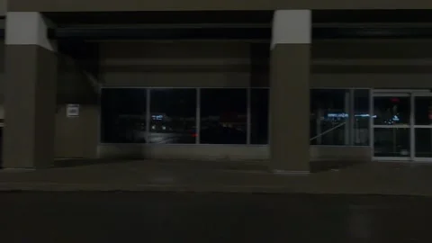 POV driving plate side view of closed retail stores at night in COVID lockdown Stock Footage 149464940