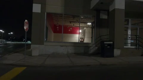 POV driving plate side view of closed retail stores at night in COVID lockdown Stock Footage 149465033