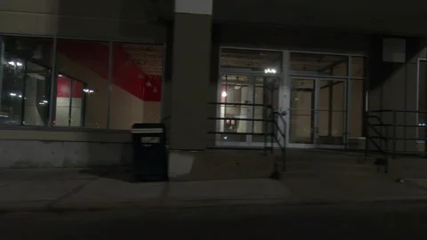 POV driving plate side view of closed retail stores at night in COVID lockdown Video stock 149465332