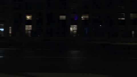 POV driving plate with side view on dark city streets at night with buildings Stock Footage 149467942