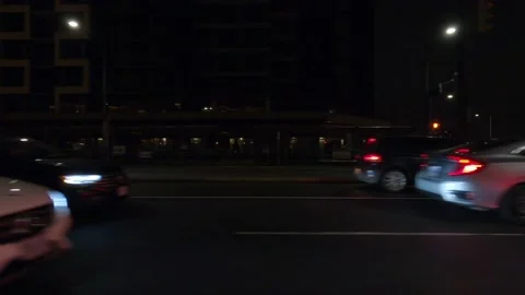 POV driving plate with side view on dark city streets at night with buildings Vidéo 149468649