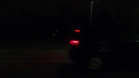 POV driving plate with side view on dark city streets at night with buildings Video stock 149469611