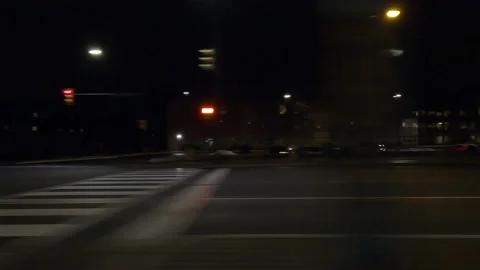 POV driving plate with side view on dark city streets at night with buildings Stock Footage 149470691