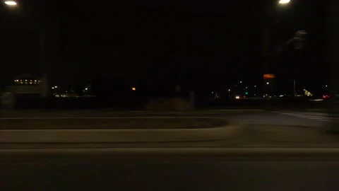 POV driving plate with side view on dark city streets at night with buildings Video stock 149470999