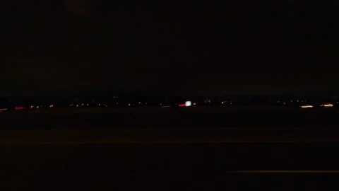 POV driving plate side view on dark city streets at night Stockbeeldmateriaal 149711520