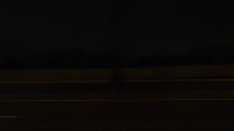 POV driving plate side view on dark city streets at night Stockbeeldmateriaal 149712646
