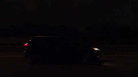 POV driving plate side view on dark city streets at night Stockbeeldmateriaal 149716474
