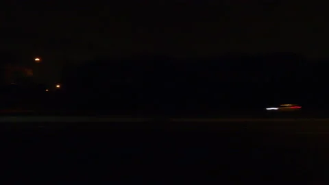 POV driving plate side view on dark city streets at night Stockbeeldmateriaal 149722807