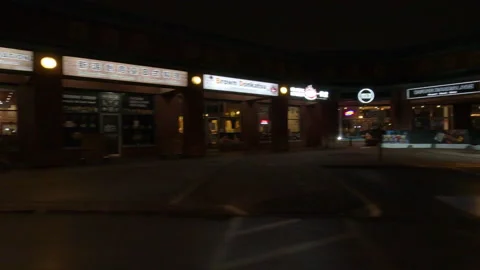 POV driving plate side view of closed retail stores at night in COVID lockdown Stock Footage 149758257