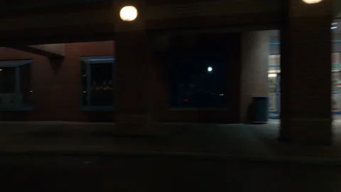 POV driving plate side view of closed retail stores at night in COVID lockdown Vídeos de archivo 149761326