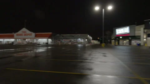 POV driving plate side view of closed retail stores at night in COVID lockdown Stockbeeldmateriaal 149769029