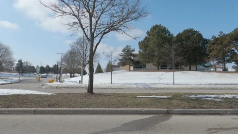 POV driving plate side view of empty university campus in COVID pandemic Stock Footage 149910092