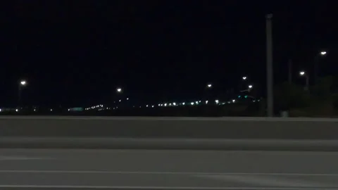 POV driving plate side view city streets on a very dark night Stock Footage 154220424
