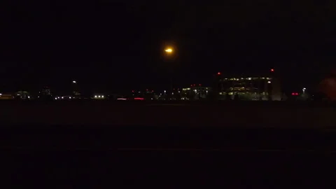 POV driving plate side view city streets on a very dark night Stock Footage 154221274