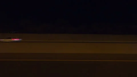 POV driving plate side view city streets on a very dark night Stock Footage 154221597