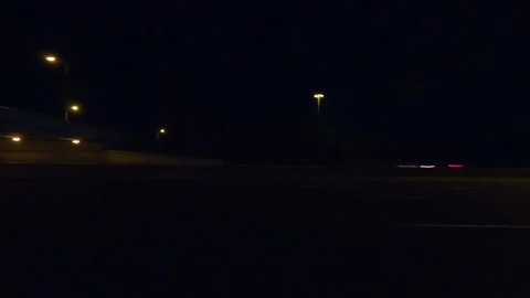 POV driving plate side view city streets on a very dark night Video stock 154223636