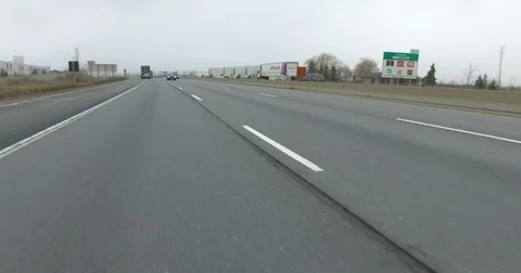 POV driving rear view on highway with tractor trailer trucks and car traffic Stock Footage 72816352