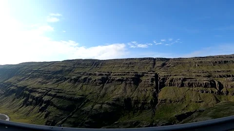 POV driving shot of steep basalt cliffs and valley in East Iceland Stock Footage 333915529