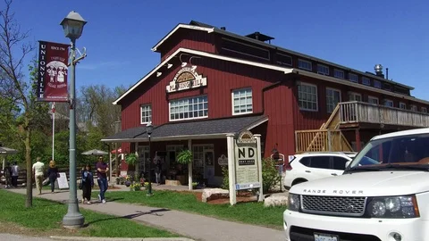 POV driving small town main street stores and shops on a sunny summer day Stock Footage 89738480