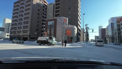 POV driving on snowy city intersection in Asahikawa Japan Vídeo Stock 333313983