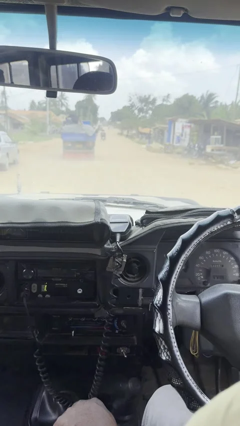 POV driving through dusty local town Mikese Tanzania in vehicle vertical Stock Footage 344476810