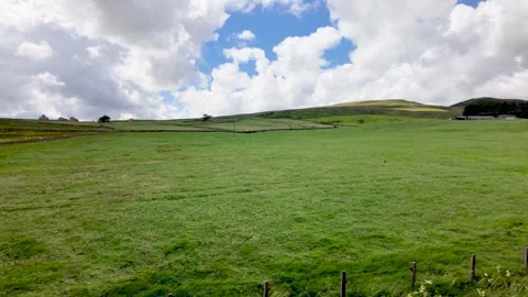 POV Driving Through Idyllic Rolling English Countryside with Green Fields and Stock Footage 339378180