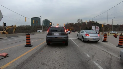 POV driving through road construction on city streets Stock Footage 98438804