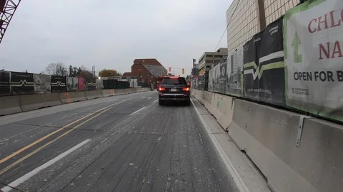 POV driving through road construction on city streets Stock Footage 98442381