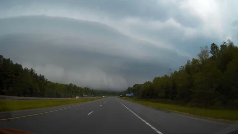 POV driving towards massive tornado warned  supercell severe thunderstorm Stock Footage