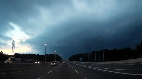 POV driving towards storm with tornado warning in effect Stock Footage