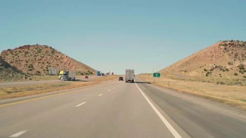 POV driving uphill on interstate 40 Arizona desert behind a truck on clear day Video stock 164117523