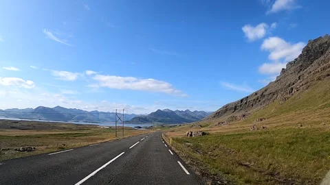 POV driving on a winding road through a scenic valley in East Iceland Vídeos de archivo 333979676