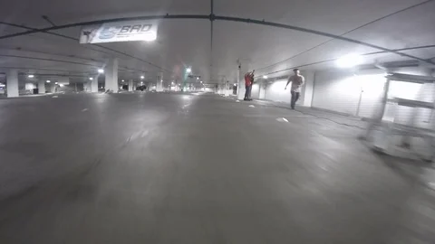 POV of a drone competition taking place in a parking lot Stock Footage 99050382