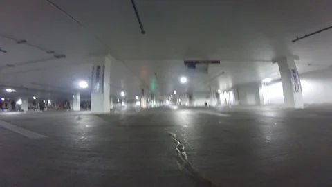 POV of a drone competition taking place in a parking lot Stock Footage 99050533