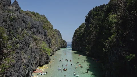 POV drone inder in a big lagoon under canoes in palawan, fpv flight Stock Footage 273175426