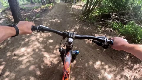 POV: Dynamic first-person ride on a gravel surface with sharp turns. Capturing Stock Footage 317701341