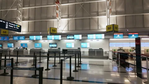 POV Empty airport check in counters with digital screens, queue barrie Stock Footage 325692706