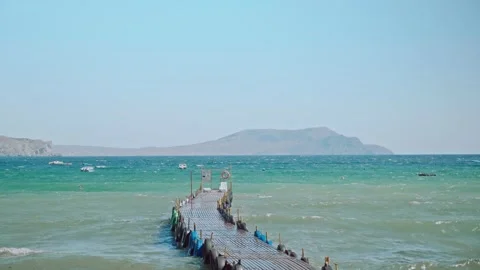 POV of empty berth for ships washed by clear blue sea on warm summer sunny day Stock Footage 196297334