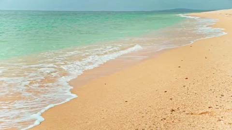 POV on empty golden sandy beach washed by ocean with crystal clear blue water. Stock Footage 197332078