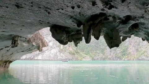 POV exiting cave to Ha Long Bay with limestone islands Vietnam Stock Footage 335279975