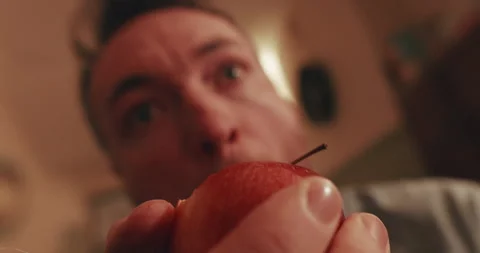 POV Experience of Taking a Bite from a Fresh Apple in Close-Up View Stock Footage 329010688
