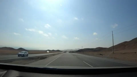 POV fast camera driving between picturesque hills on the highway with clear sky Stock Footage 197122731