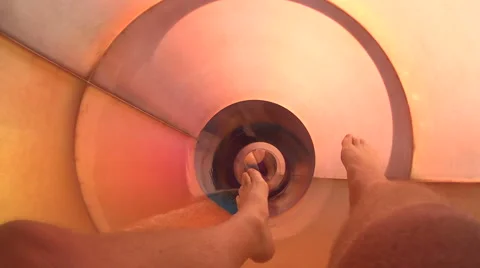 POV of feet going down tube slide at waterpark in summer Stock Footage