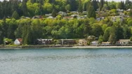 Pov- Ferry Passing Houses Tree On Bainbridge Island Shoreline. Stock Footage