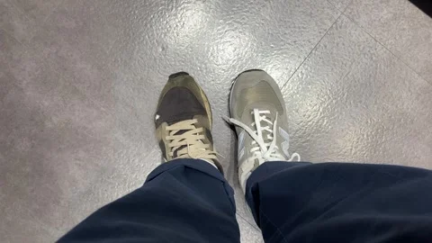 POV first person looking down at feet trying on sneakers shoes. Old and new Stock Footage 282860364